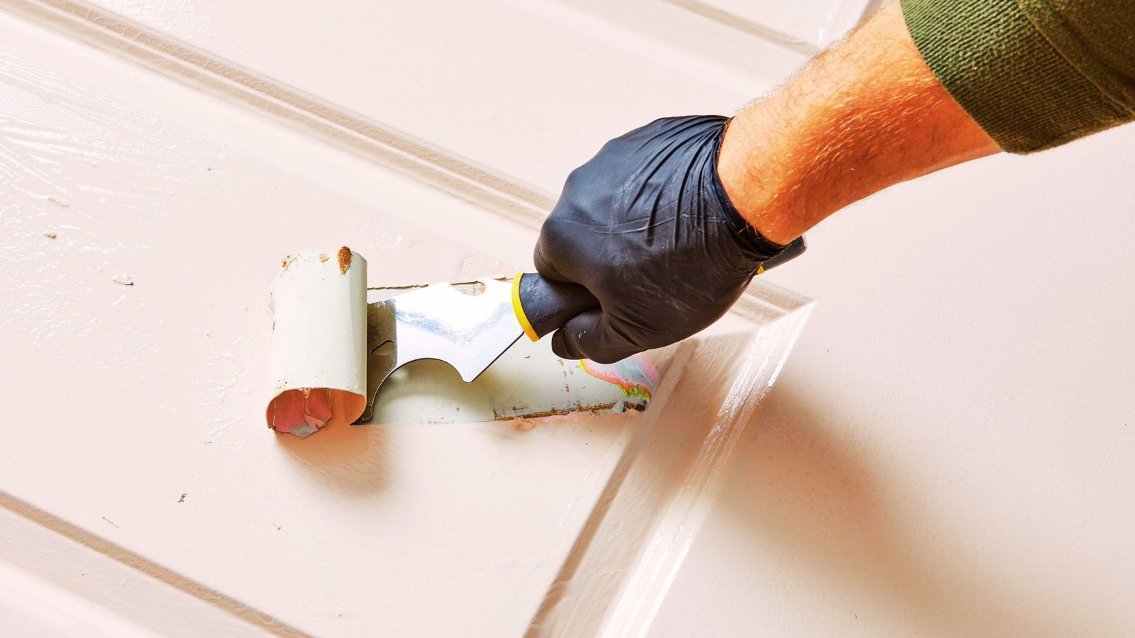 Scraping softened chalk paint from wood.