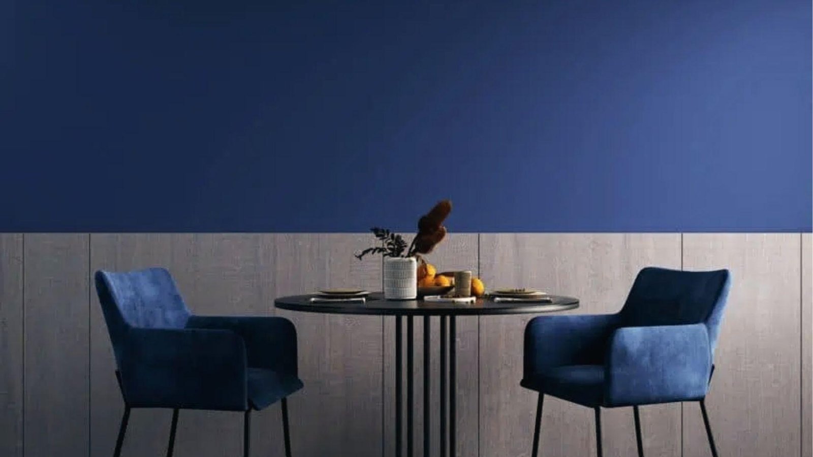Dining nook showcasing navy blue upper wall over wood paneling with round table and blue chairs.