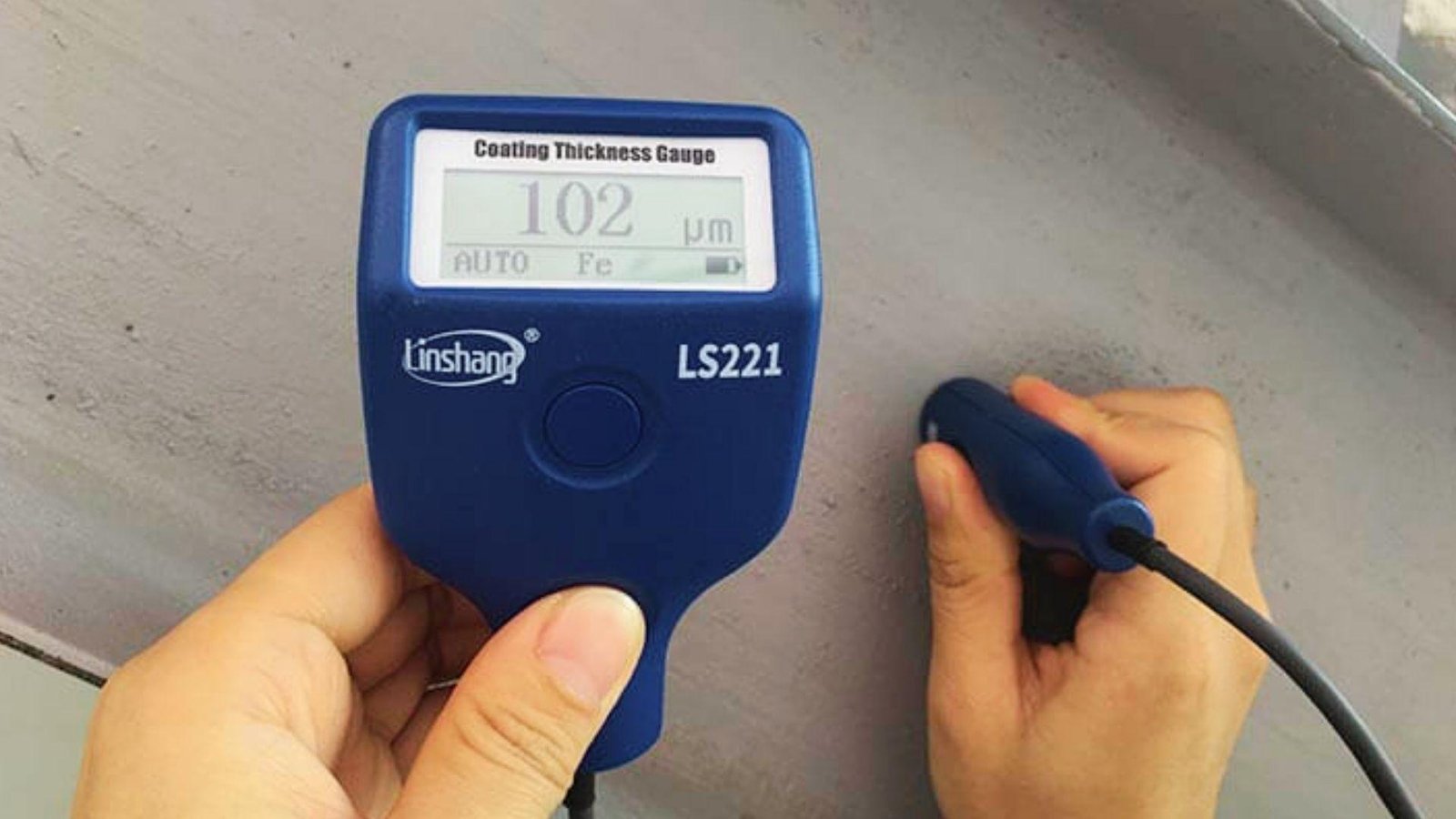 Using coating thickness gauge to check dry paint layers, ensuring correct drying time between coats