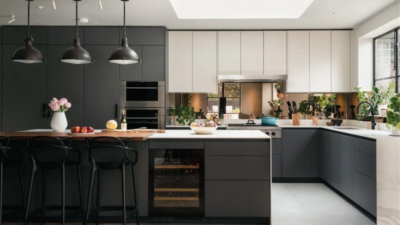 Matte black lowers, light gray uppers, white counters, wood island top, sleek industrial color balance