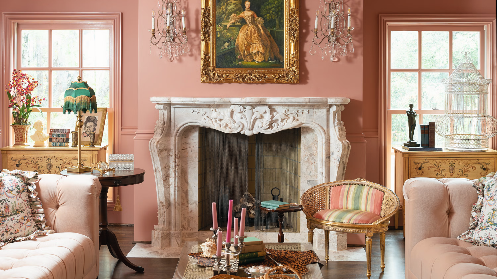 Ornate living room with blush pink walls and marble fireplace showcasing classy interior paint.