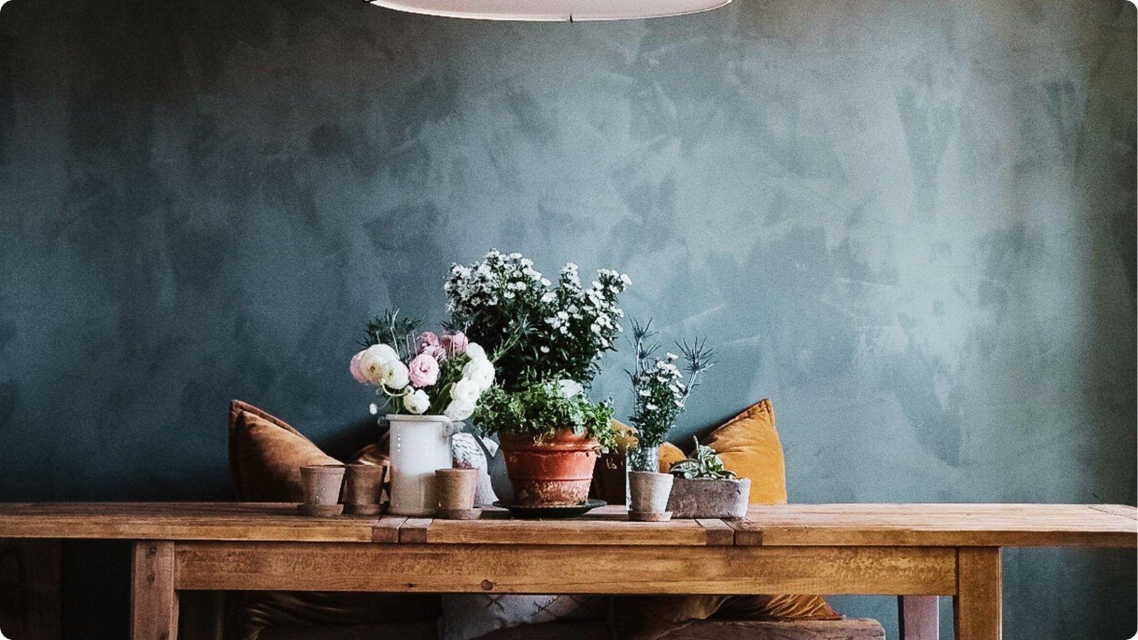 Moody dining nook with teal lime wash faux finish showing subtle tonal variations and cloud-like texture.