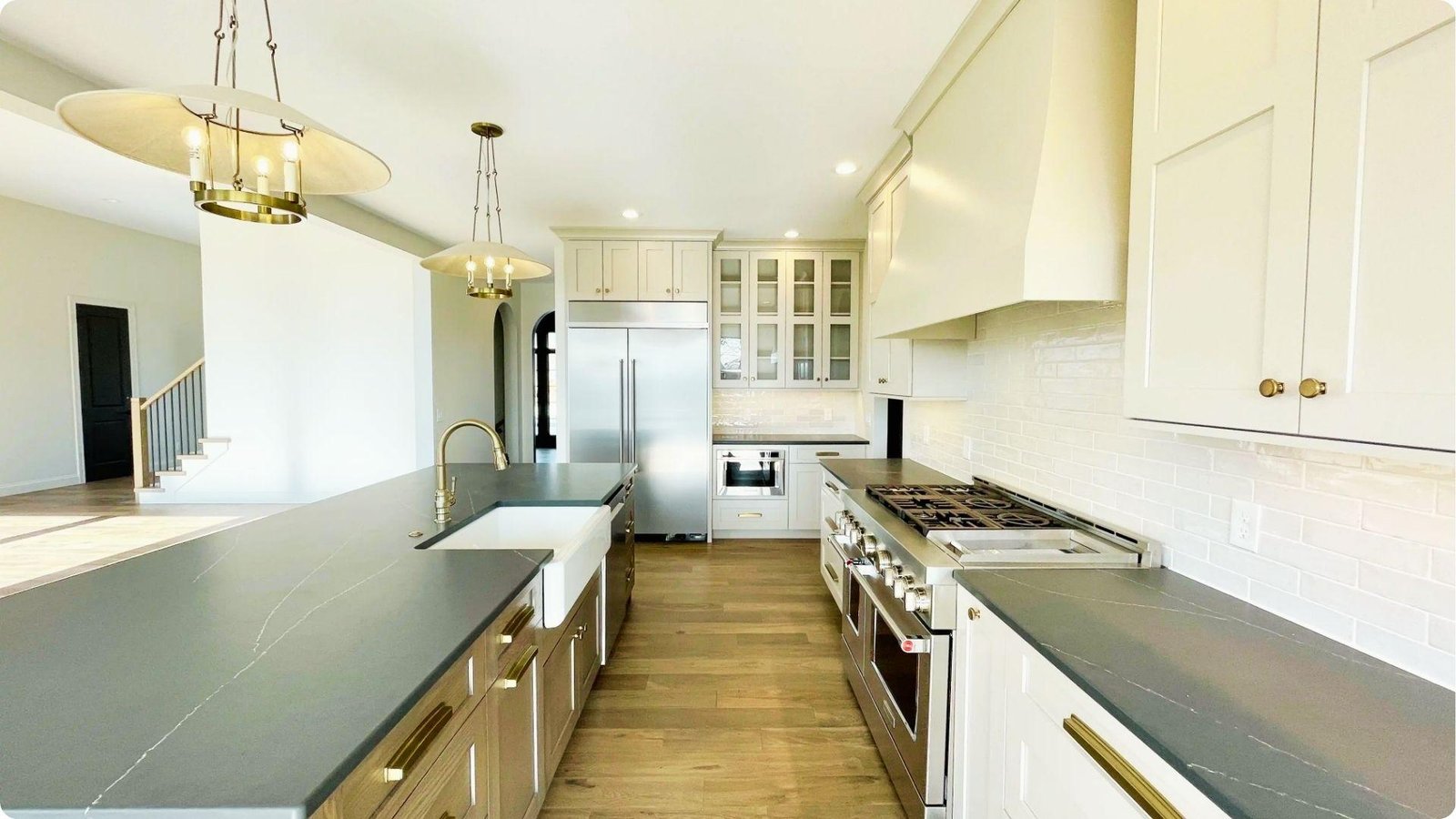 Bright farmhouse kitchen with creamy off-white wall paint and white shaker cabinets.