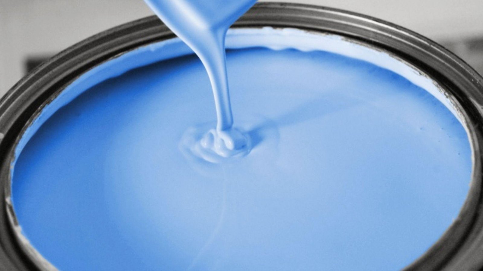 Blue paint pouring into can, water-based vs oil-based paint changes dry time between coats