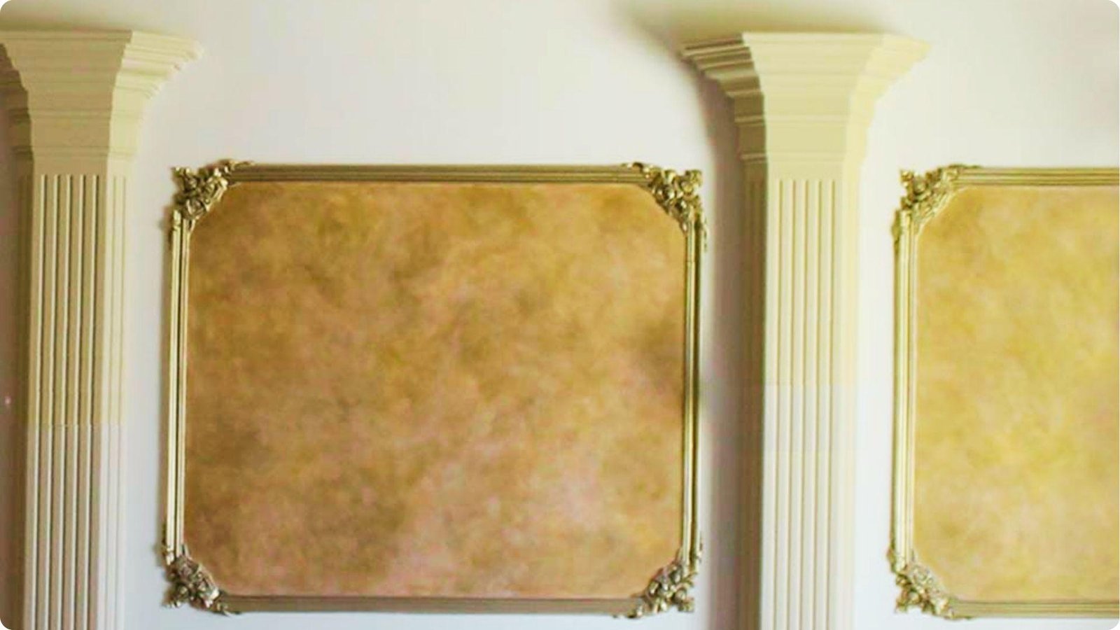 Antique gold faux finish applied inside ornate wall panels framed by fluted columns.