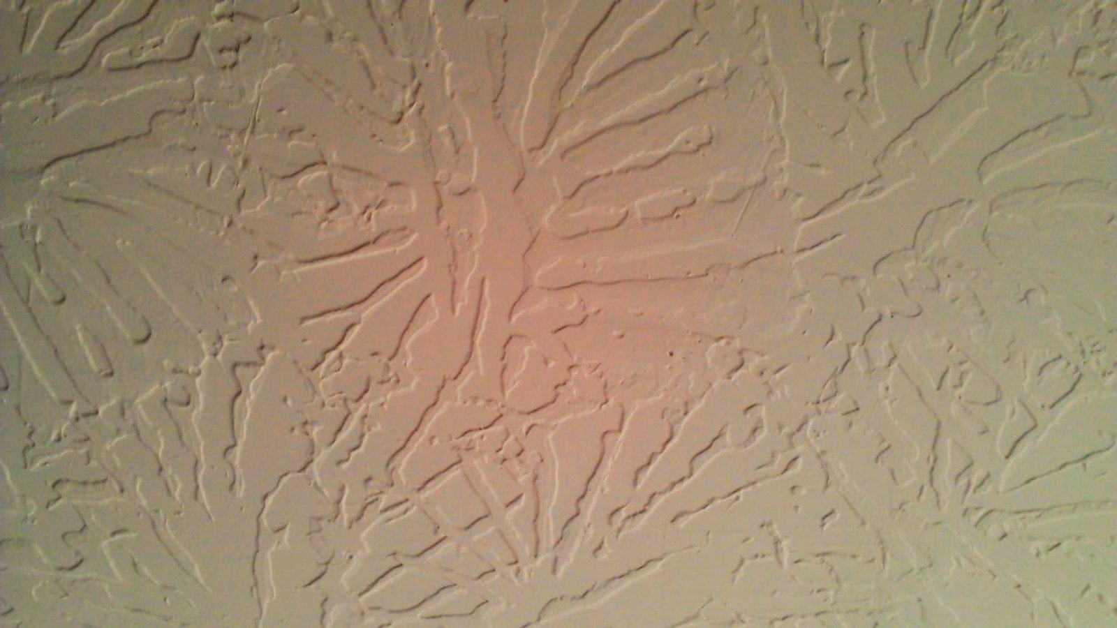 Slap brush textured wall with decorative patterns.