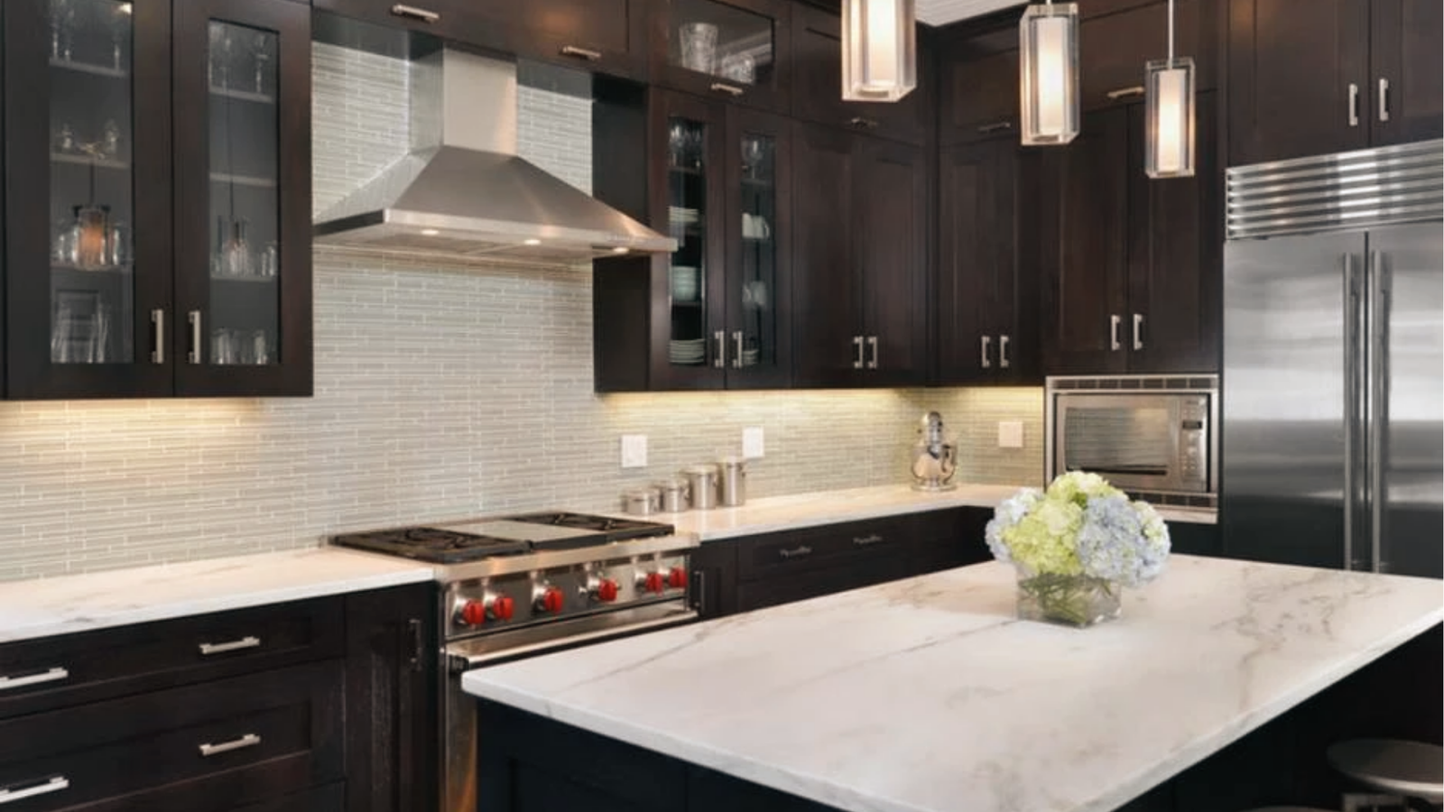 Dark espresso cabinets, light gray linear tile backsplash, white quartz, cool contemporary contrast scheme