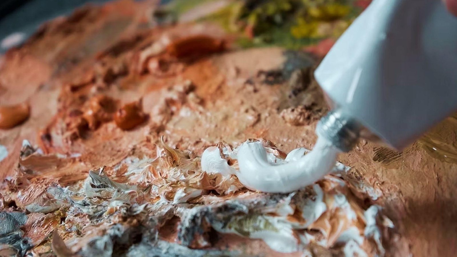 White paint squeezed onto textured palette, thicker paints need longer drying time between coats