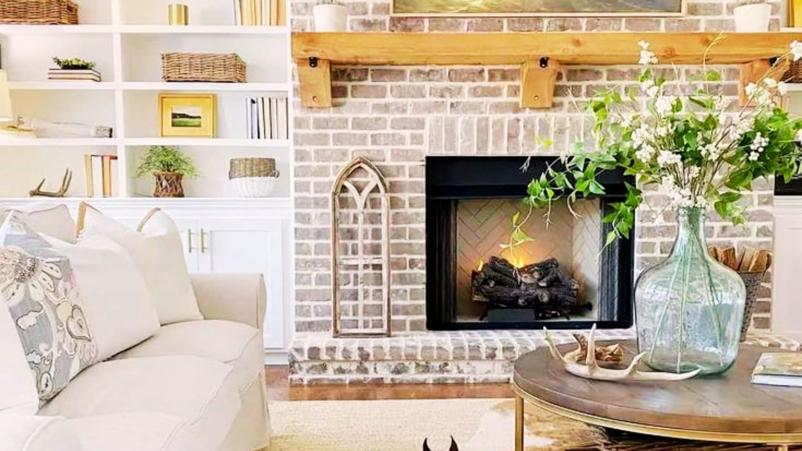 Rustic limewashed brick fireplace with soft chalky texture in a cozy living room.