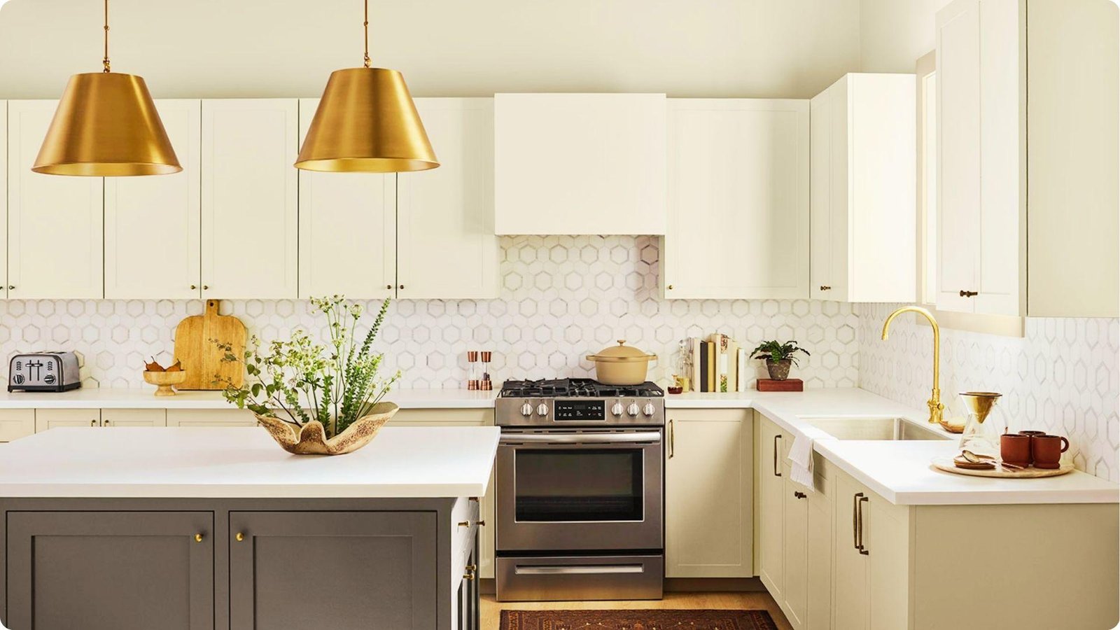 Farmhouse kitchen with greige wall paint, off-white upper cabinets, and dark gray island base.