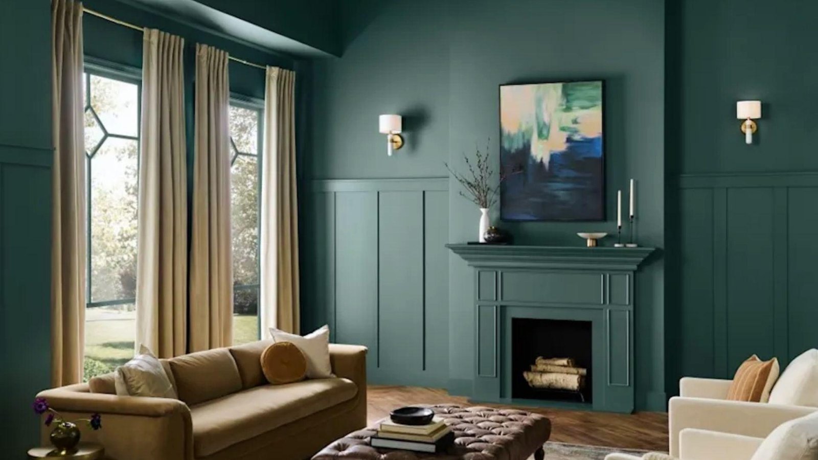 Elegant living room with dark teal trim paint on fireplace, wainscoting, and crown molding for dramatic home design
