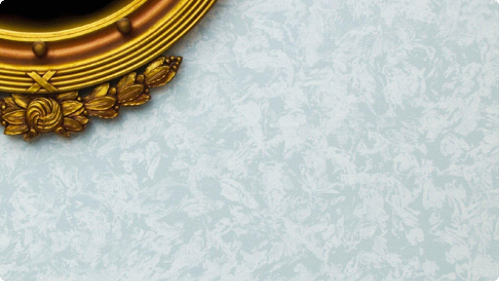 Pale blue wall with rag rolling faux finish creating soft, mottled texture and depth.